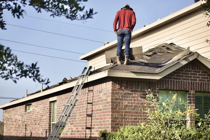 Professional roofer working on a residential roof in Verdi
